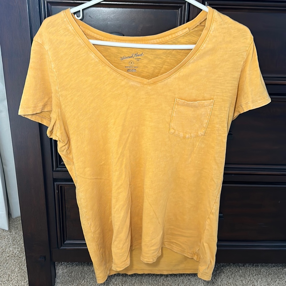 Universal threat yellow pocket tee